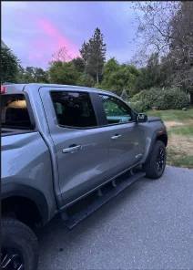 Grey pickup truck in a driveway at dusk