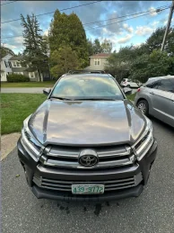 Toyota SUV parked in a tree-lined driveway